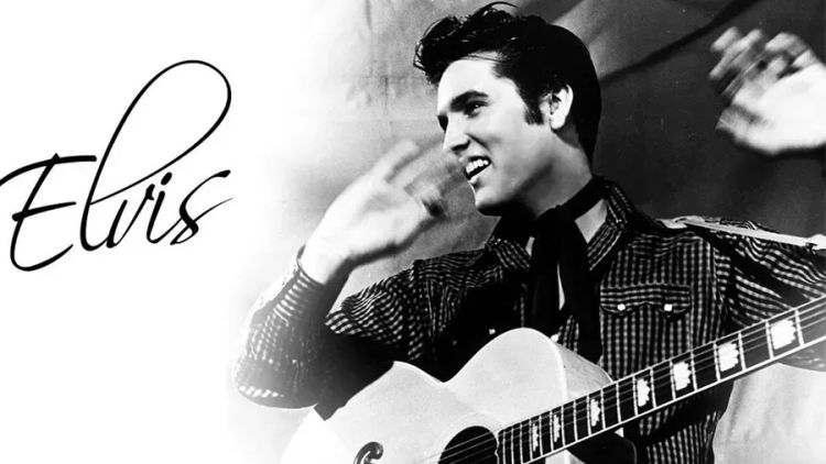 A black and white photo of a man playing a guitar, with the name 'Elvis' written beside him.