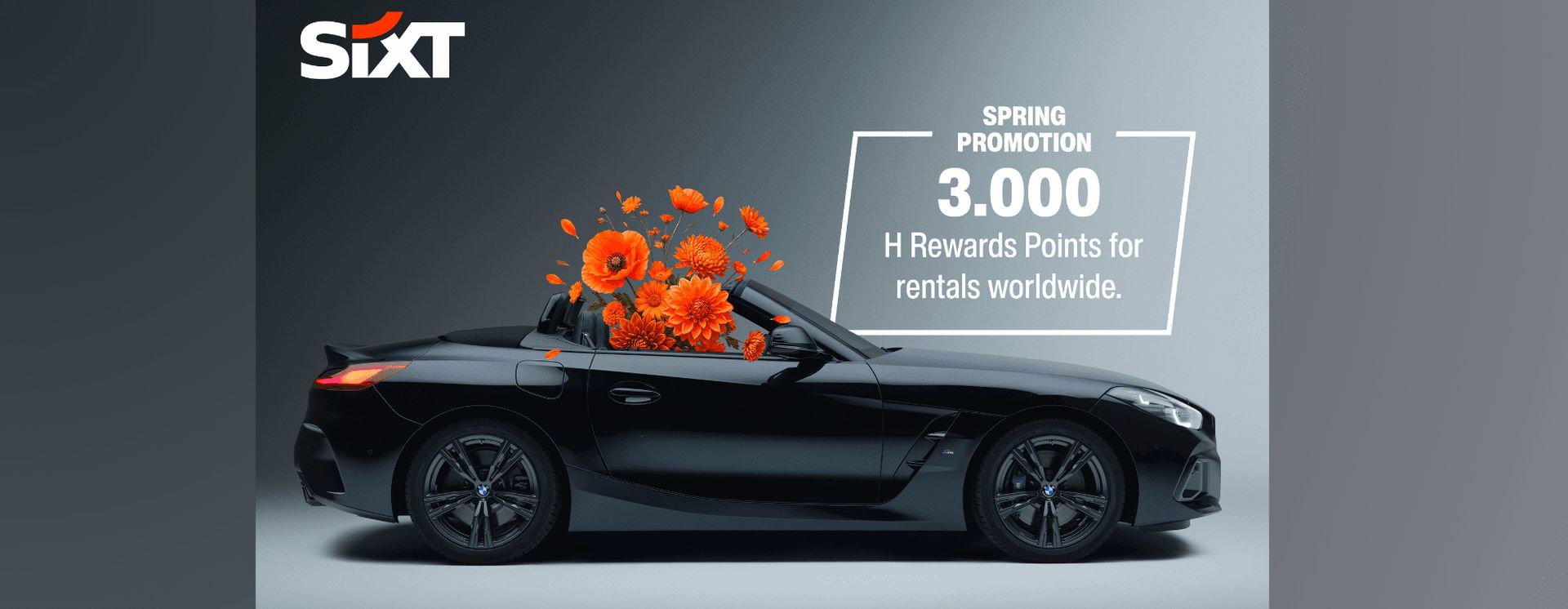 En svart cabriolet med orange blommor som kommer ut från den, tillsammans med text som marknadsför…