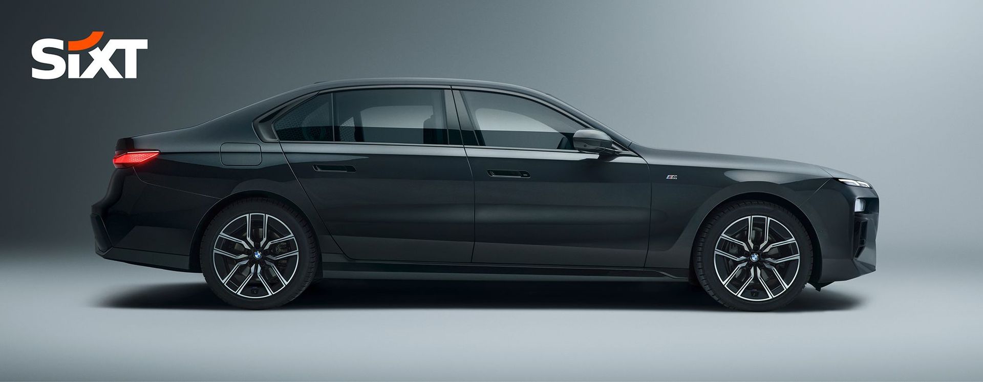 The photo shows a black luxury sedan car with the Sixt logo in the top left corner.