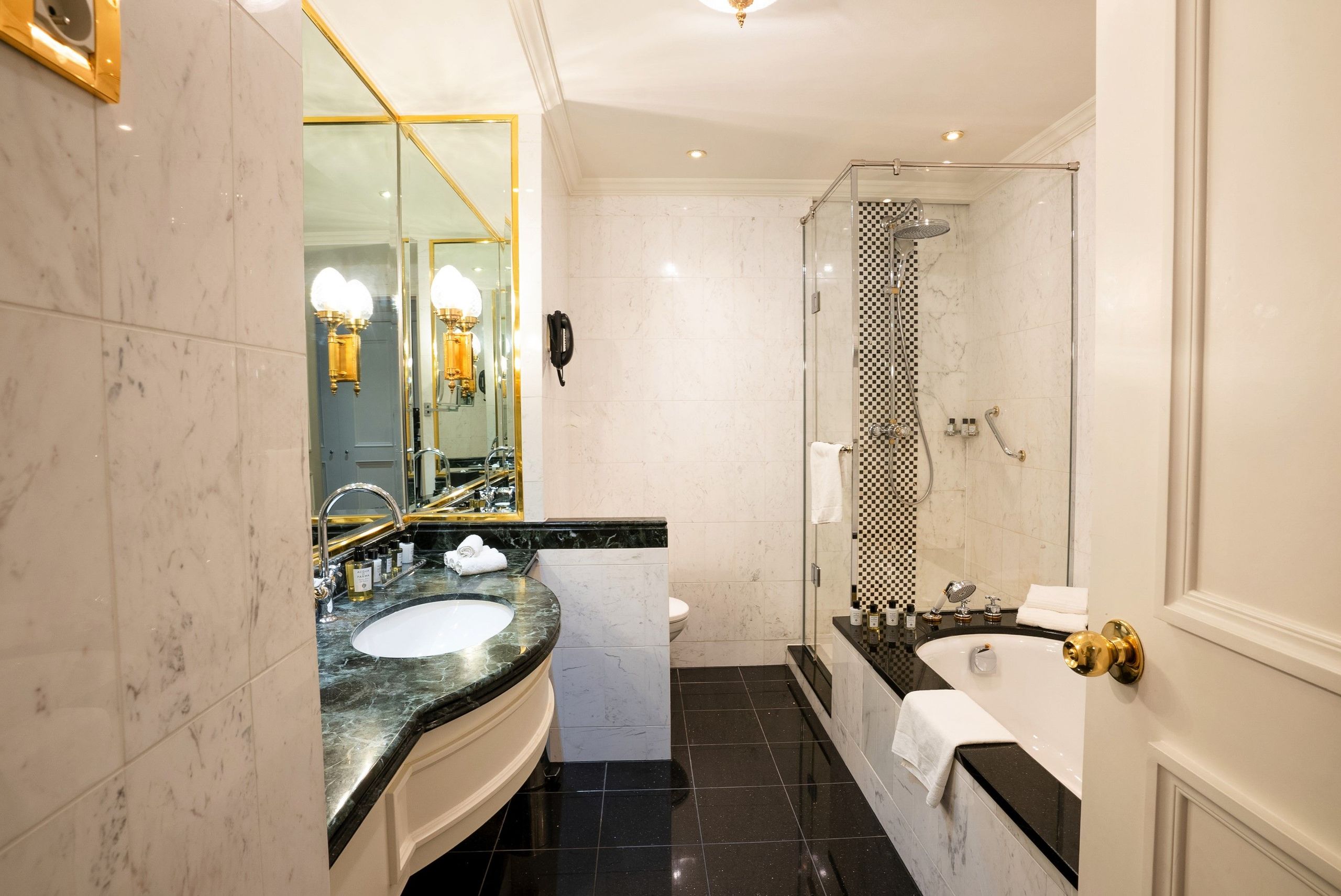 Une salle de bain moderne avec un lavabo et un comptoir, une douche vitrée et une baignoire.