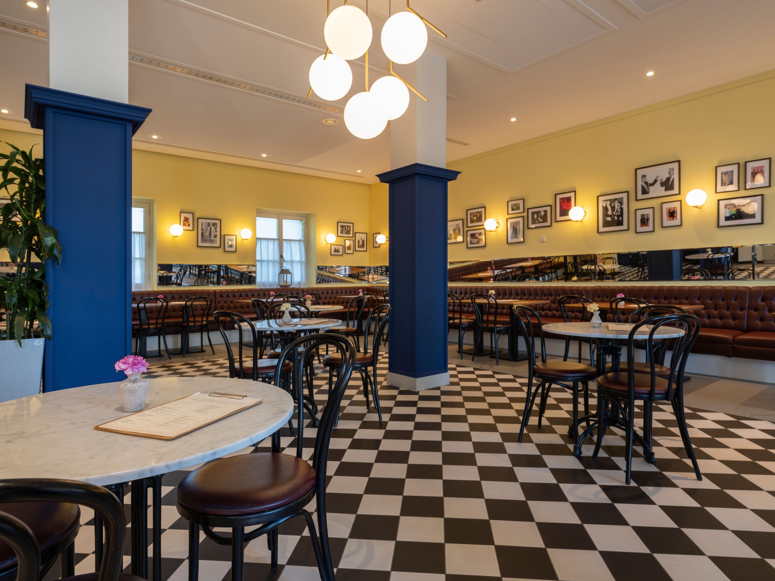 Das Bild zeigt das schön dekorierte Interieur eines Cafés oder Restaurants mit schwarz-weiß…