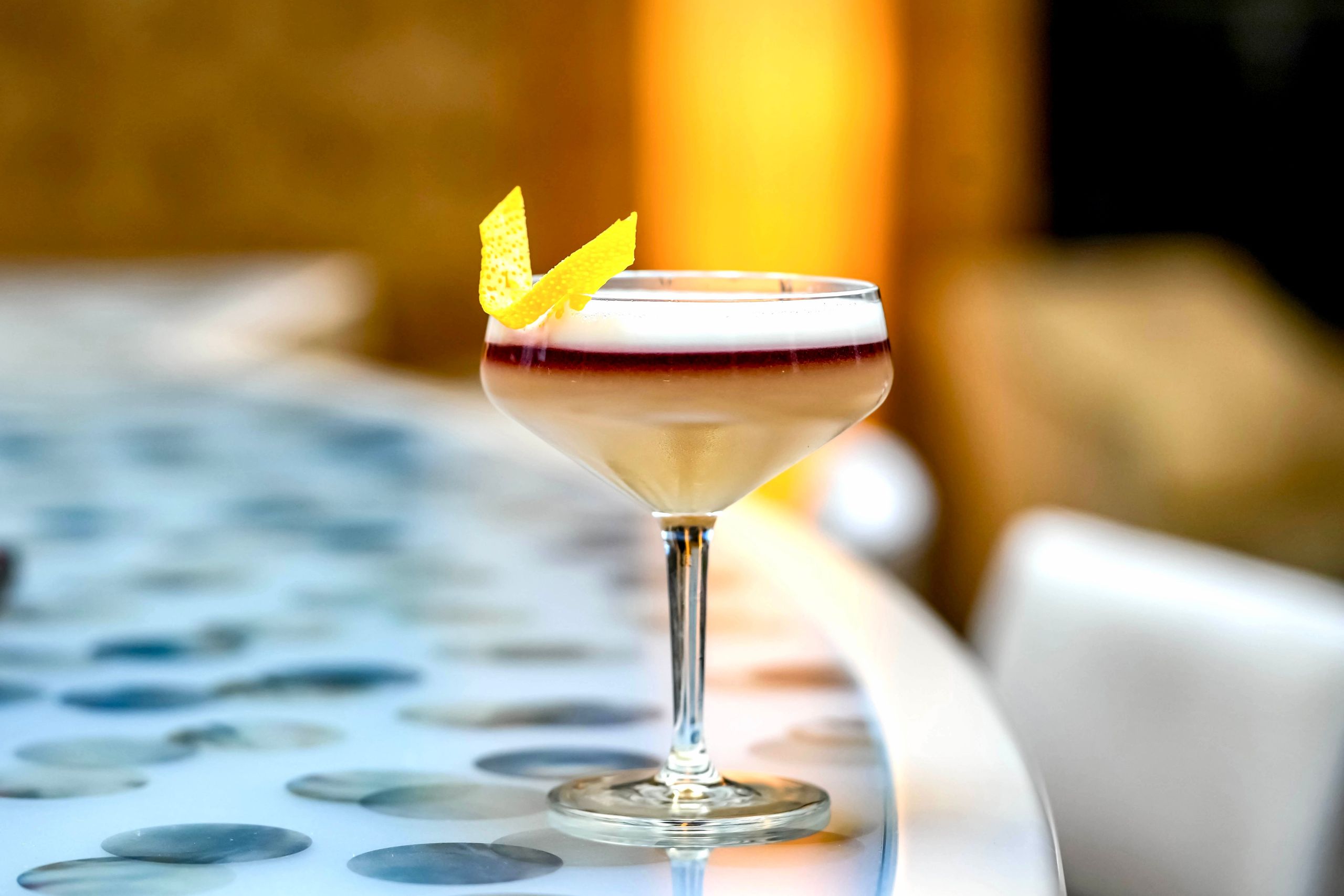 A cocktail in a glass on a table.